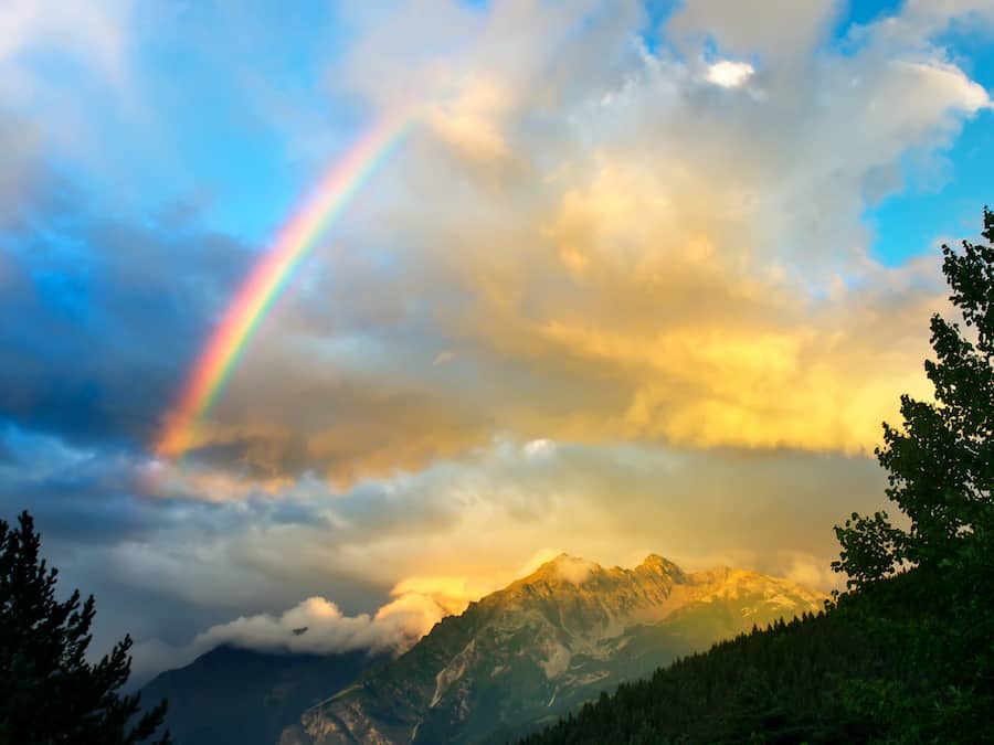 rainbow over rugged mountains
