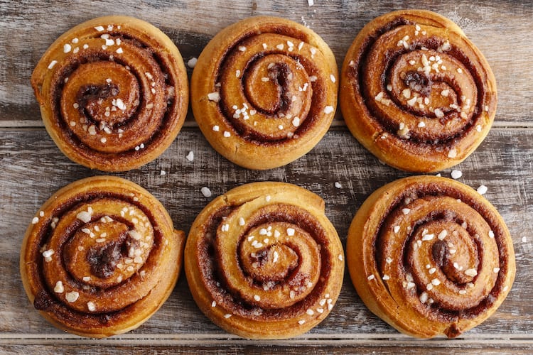 Six sweet rolls on a wooden table